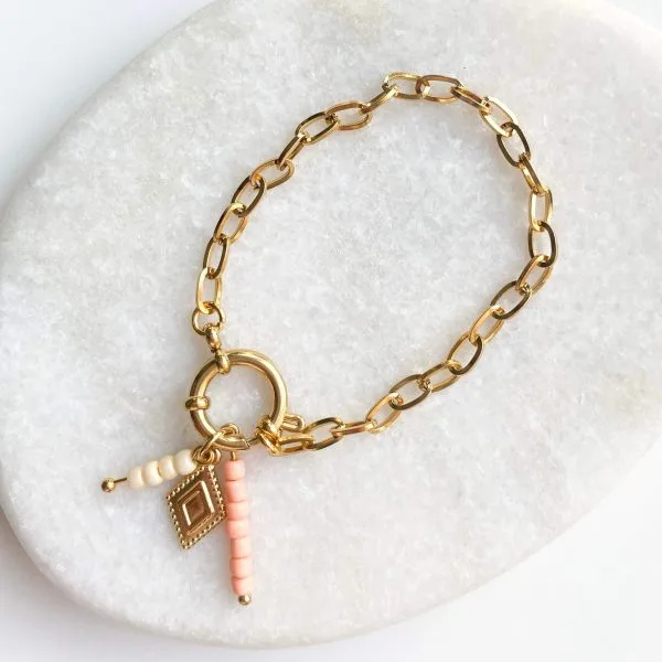 Schakelarmband party ruitje goud/zalm